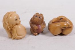 Three carved tagua nut netsuke carved as carved as a lion, bear and two ducks, 1½" long