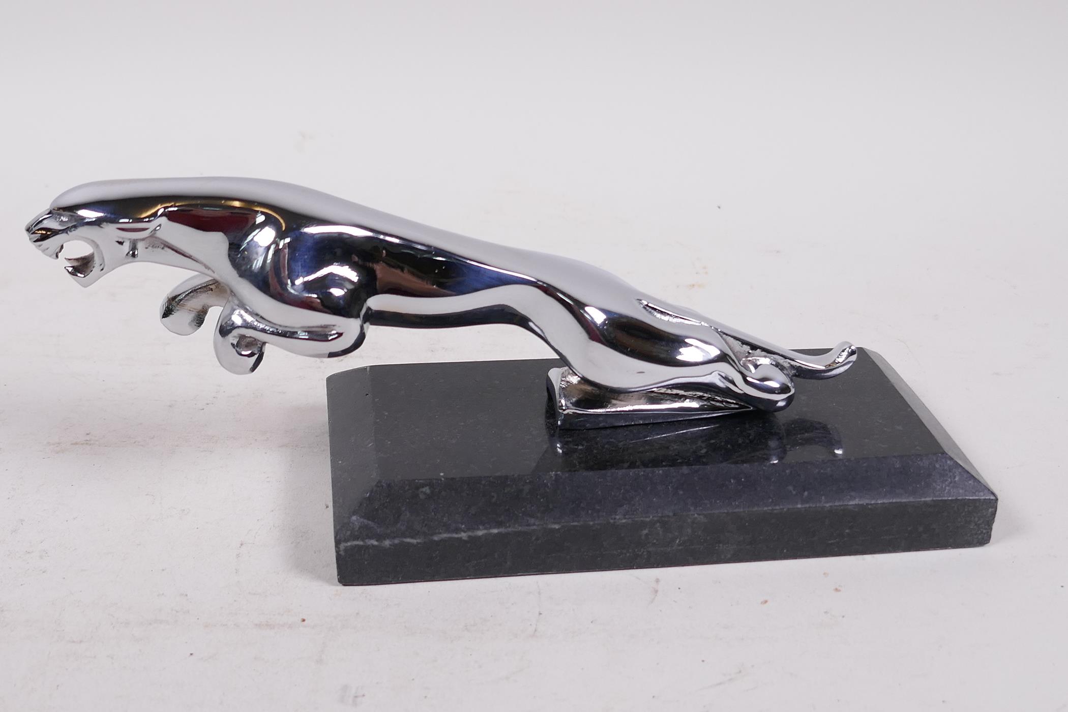 A chromium plated replica Jaguar car mascot mounted on a marble base, 7½" long