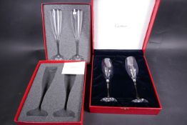 A pair of Baccarat glass champagne flutes in a presentation box, together with a similar pair of