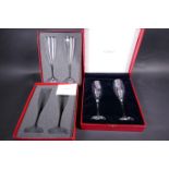 A pair of Baccarat glass champagne flutes in a presentation box, together with a similar pair of