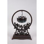 An Oriental bronze hanging incense burner in the form of a lotus flower, 10" high