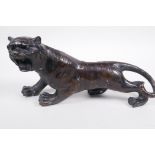 A Oriental bronze figure of a roaring tiger, 12½" long