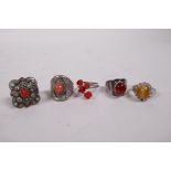 Five silver and white metal rings set with coral and semi-precious stones