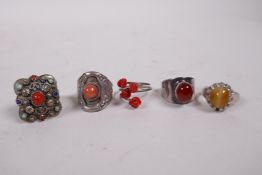 Five silver and white metal rings set with coral and semi-precious stones