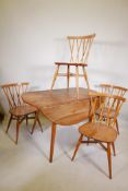 A mid C20th Ercol elm dropleaf dining table on splayed legs, and a set of four Ercol elm 'Shalstone'