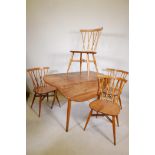 A mid C20th Ercol elm dropleaf dining table on splayed legs, and a set of four Ercol elm 'Shalstone'