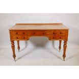 A Victorian five drawer faded mahogany kneehole desk, raised on turned supports, 48" x 21" x 30"