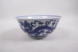 A Ming style blue and white porcelain bowl with dragon decoration, 6 character mark to base, Chinese