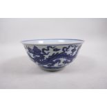 A Ming style blue and white porcelain bowl with dragon decoration, 6 character mark to base, Chinese