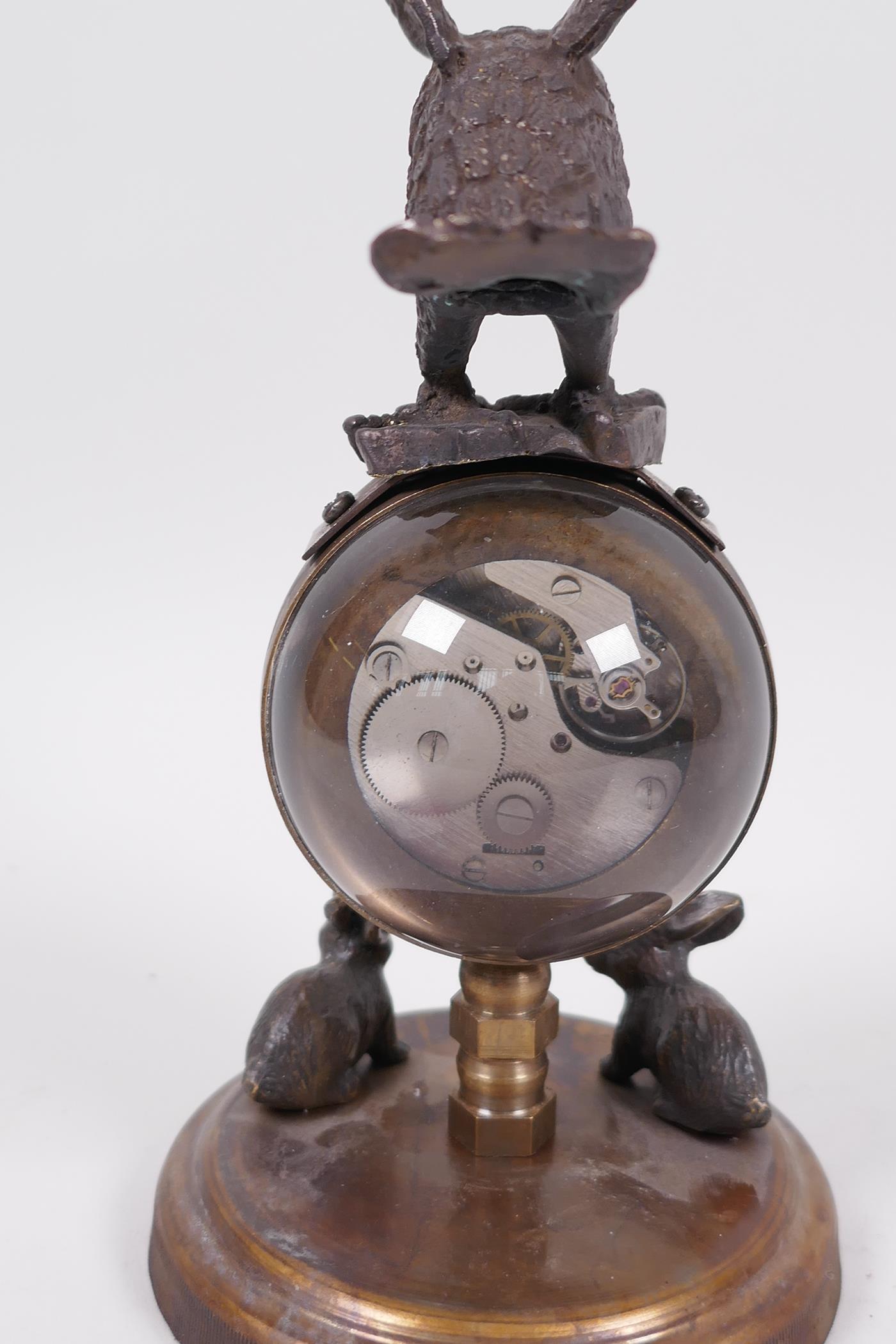 An unusual desk top ball clock, the base with two cast figures of rabbits, the clock surmounted with - Image 5 of 5