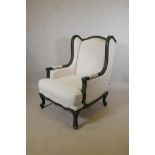 A contemporary wingback armchair, the frame with distressed paint finish, retailed by 'The One', 43"