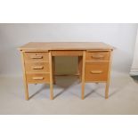 A light oak utilitarian kneehole desk with four drawers and a stationary slide, 48" x 24½", 30" high