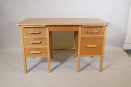 A light oak utilitarian kneehole desk with four drawers and a stationary slide, 48" x 24½", 30" high