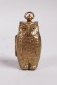 A brass owl shaped sovereign and half sovereign case, 2½"