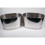A pair of large plated metal champagne coolers, engraved with aphorisms from Lily Bolinger and