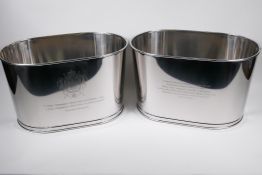 A pair of large plated metal champagne coolers, engraved with aphorisms from Lily Bolinger and