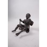 An Oriental part bronze of a figure on a swing, 7"