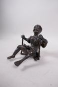 An Oriental part bronze of a figure on a swing, 7"