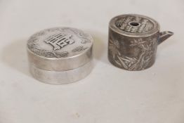 A Chinese white metal jar and cover with raised decoration, 2½" diameter, and a white metal pourer