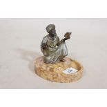 A spelter figure of a Moor preaching from a book, mounted on a Sienna marble base, 4" high