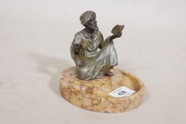 A spelter figure of a Moor preaching from a book, mounted on a Sienna marble base, 4" high