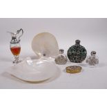 Three glass scent bottles with pierced white metal decorative mounts, a perfume bottle in the form