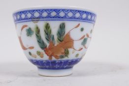 A porcelain tea bowl decorated with carp amongst water weeds, Chinese seal mark to base, 3" diameter