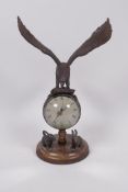 An unusual desk top ball clock, the base with two cast figures of rabbits, the clock surmounted with