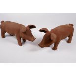 A pair of cast iron garden figures of pigs, 17" long