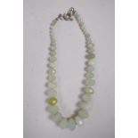 A graduated string of faceted green jade beads, 20" long