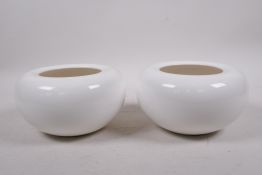 A pair of Oriental white glazed porcelain vases with rolled rims, impressed marks to base, 3½"