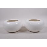 A pair of Oriental white glazed porcelain vases with rolled rims, impressed marks to base, 3½"