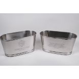 A pair of plated metal wine coolers engraved with aphorisms from lily Bolinger and Napoleon