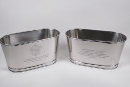 A pair of plated metal wine coolers engraved with aphorisms from lily Bolinger and Napoleon
