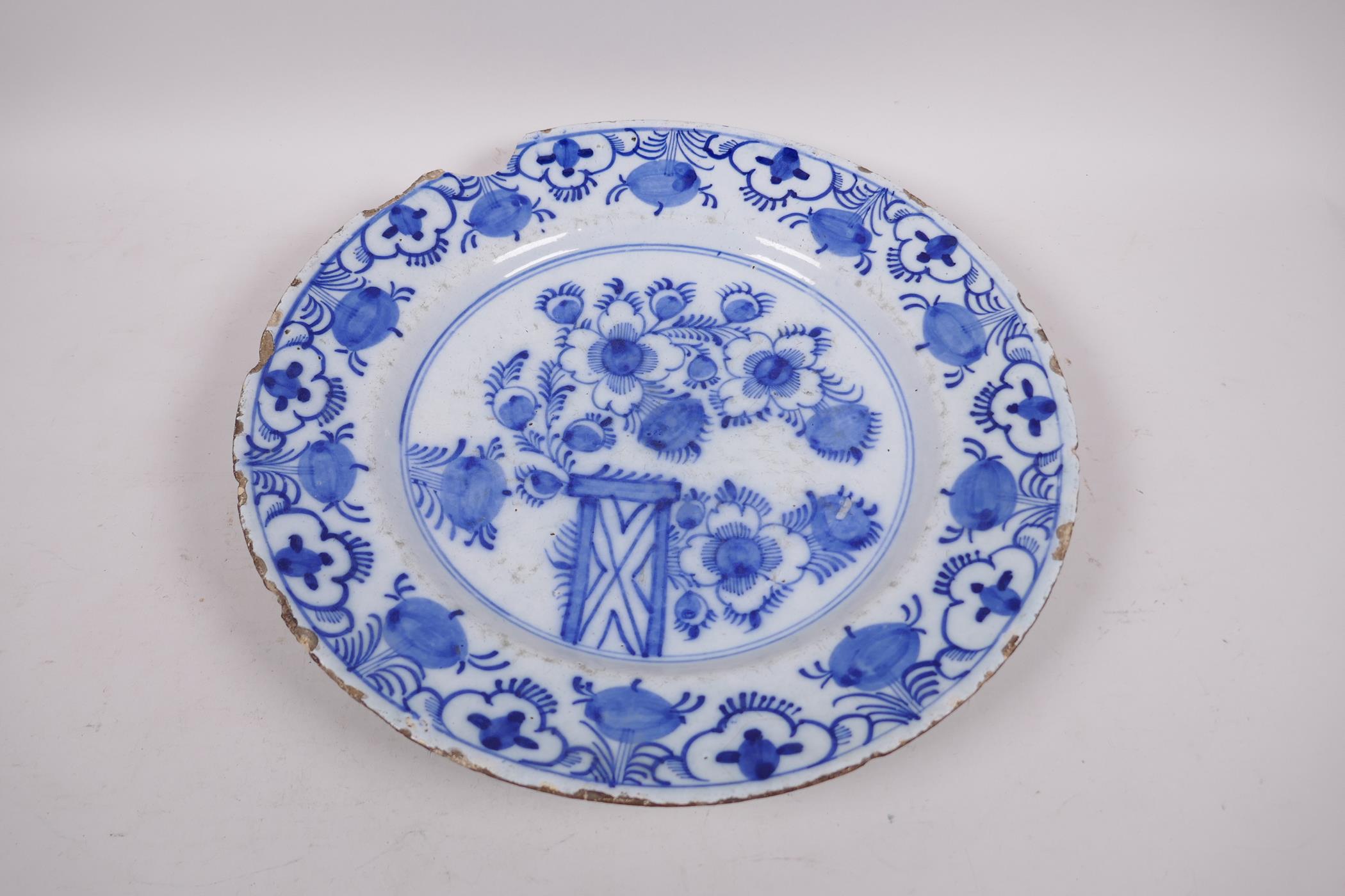 An antique Delft tin glazed blue and white charger painted with flowers and fruit, chip to rim, 13½" - Image 2 of 5