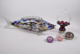 A Murano glass fish, together with a Murano Burgundy glass basket, and three millefiori glass