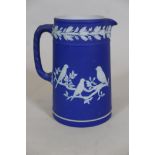 A Wedgwood blue Jasperware jug with raised bird decoration, 6½" high
