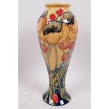 A Moorcroft pottery vase decorated with poppies, marked 'Trial', 11" high