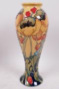 A Moorcroft pottery vase decorated with poppies, marked 'Trial', 11" high
