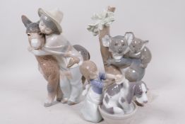 Three Lladro figurines, boy hugging a donkey, koala and baby on a tree, and young girl bathing her