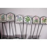 A set of twelve painted cast iron herb markers, 3" x 2¾"