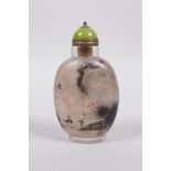 A Chinese reverse decorated glass snuff bottle decorated with travellers in landscape scenes to