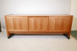 A Danish Dyrlund mid century figured teak sideboard with sliding doors, 77" x 19", 30" high