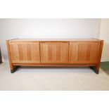 A Danish Dyrlund mid century figured teak sideboard with sliding doors, 77" x 19", 30" high