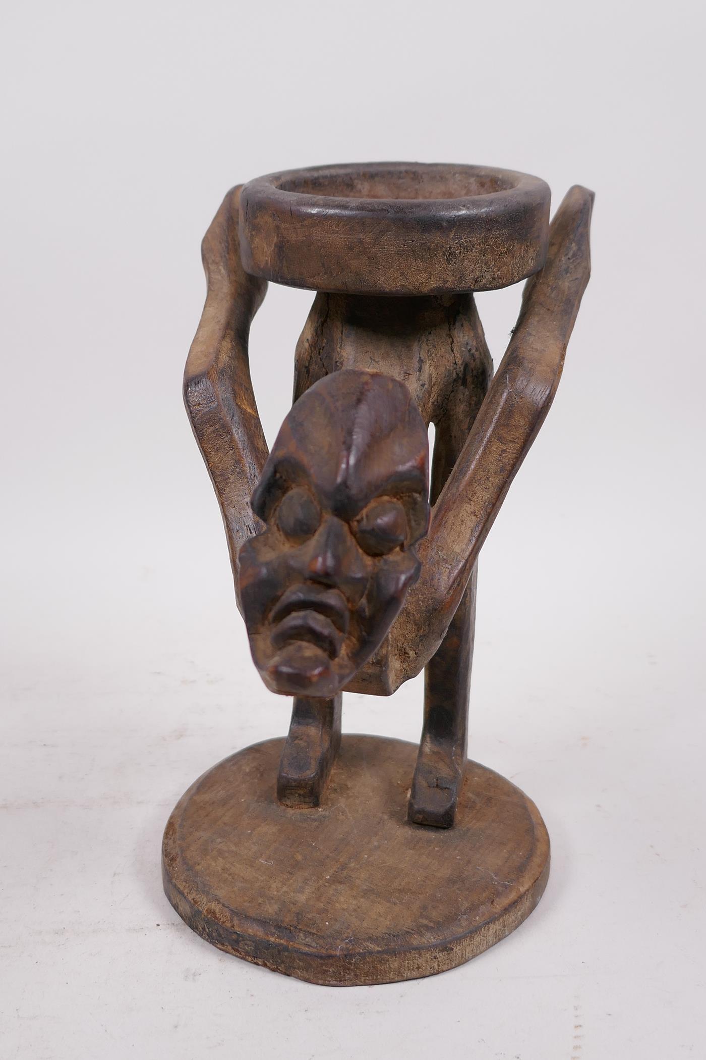 An unusual Indonesian wood figure carved as a stand, 9" high - Image 2 of 4