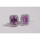 A pair of 18ct white gold, pink sapphire and diamond earrings, 1.57cts