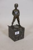 A bronze figure of a young boy on skis, impressed Ferdinand Paris, with a foundry mark, BJB,