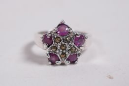 A silver ring set with marcasite and pink stones, approximate size 'N'