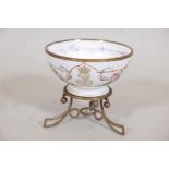 A Sevres bowl, hand painted with swags of roses and gilt highlights, raised on an ormolu base,