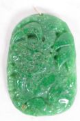 A Chinese carved green hardstone pendant, 2½" long